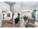 Inviting living room with vaulted ceiling showcases staircase and flows into dining area for entertaining at 1846 N Sunview --, Mesa, AZ 85205