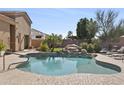 Inviting backyard pool area with rock waterfall feature and ample space for lounging at 19727 E Julius Rd, Queen Creek, AZ 85142