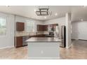 Bright eat-in kitchen features stainless steel appliances, tile backsplash, and central island at 22905 N 19Th Way, Phoenix, AZ 85024
