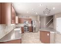 Well-lit kitchen with stainless steel appliances, ample counter space, and stylish tiled backsplash at 22905 N 19Th Way, Phoenix, AZ 85024