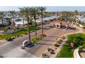 Gated community entrance with lush landscaping, including mature palm trees and well-maintained green spaces at 2550 E Ellsworth Rd # 791, Mesa, AZ 85209