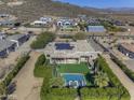 Aerial view showcasing the property's pool, landscaped backyard, desert surroundings, and solar panels at 2729 W Dolores Rd, Phoenix, AZ 85086