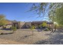 Desert home boasting xeriscape landscaping, neutral color palette, and mature trees in a serene setting at 2729 W Dolores Rd, Phoenix, AZ 85086