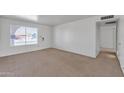 Bright living room with carpeted floors, a large window, and neutral walls at 2815 W Charleston Ave, Phoenix, AZ 85053