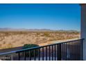 A balcony view reveals a beautiful desert landscape with mountain views in the distance at 30402 W Vale Dr, Buckeye, AZ 85396