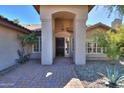 Inviting front entrance featuring brick walkway and attractive stone columns and tile roof at 309 E Mountain Sky Ave, Phoenix, AZ 85048