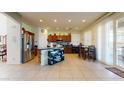 Spacious kitchen featuring stainless steel appliances, center island, and tile flooring at 33732 N Sandstone Dr, San Tan Valley, AZ 85143