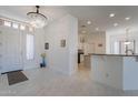 Bright foyer with marble floors, decorative chandelier and an open view into the home at 4266 E Cassia Ln, Gilbert, AZ 85298