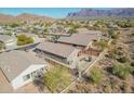 An aerial view showcases this home in a desert community with mountain views at 6589 E Casa De Leon Ln, Gold Canyon, AZ 85118