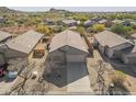 Aerial view of single Gathering home in a desert community with a low maintenance yard at 6589 E Casa De Leon Ln, Gold Canyon, AZ 85118