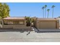 Beautiful single-story home with an attached garage, red tile roof and tidy landscaping at 7345 E Rovey Ave, Scottsdale, AZ 85250