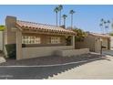 Charming home showcasing a red tile roof, neutral stucco, and tidy desert landscaping at 7345 E Rovey Ave, Scottsdale, AZ 85250