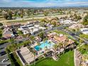 Scenic aerial view of community featuring sparkling pool, golf course, and lush landscaping at 7920 E Via Camello -- # 49, Scottsdale, AZ 85258