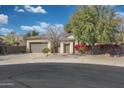 Well-maintained single-Gathering home with desert landscaping, beautiful flowering shrubbery, and a two-car garage at 800 W Palo Brea Dr, Litchfield Park, AZ 85340