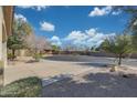 Cul-de-sac view of home featuring mature trees and desert landscaping for easy maintenance at 800 W Palo Brea Dr, Litchfield Park, AZ 85340