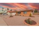 Attractive single-story home showcasing a well-maintained desert front yard, offering great curb appeal at 8012 E Monte Ave, Mesa, AZ 85209