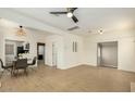 Open floor plan living room with wood floors, neutral paint, access to the kitchen, and a ceiling fan at 809 N 11Th Ave, Phoenix, AZ 85007