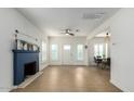 Bright living room featuring wood floors, neutral paint, a fireplace, a ceiling fan, and access to the dining area at 809 N 11Th Ave, Phoenix, AZ 85007