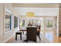 Bright dining room with a large wooden table and windows providing natural light at 8499 E Jumping Cholla Dr, Gold Canyon, AZ 85118