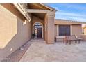 Inviting front entrance with a decorative door and a tiled patio area at 8499 E Jumping Cholla Dr, Gold Canyon, AZ 85118