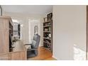 Home office featuring a wooden desk, shelving, and hardwood floors at 8499 E Jumping Cholla Dr, Gold Canyon, AZ 85118