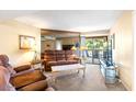 Comfortable living room with mirrored wall and bright sliding door access to outdoor patio at 9270 E Mission Ln # 211, Scottsdale, AZ 85258