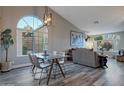 Bright dining area featuring vaulted ceilings, a large window, and modern light fixtures at 928 S San Joaquin Ct, Gilbert, AZ 85296