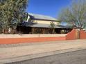 Charming home featuring a metal roof, stucco walls, desert landscaping, and covered patio at 94 W 12Th St, Florence, AZ 85132