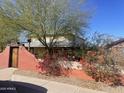 Charming house with a stucco wall, mature landscaping and a welcoming gate at 94 W 12Th St, Florence, AZ 85132