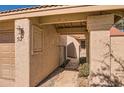 Charming covered entrance way with tile and stucco walls leading to the front door at 945 N Pasadena -- # 52, Mesa, AZ 85201