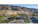 Aerial view of a community pool with mountain views and landscaping at 9814 S 11Th St, Phoenix, AZ 85042