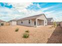 Spacious backyard with desert landscaping, a covered patio, and ample room for outdoor activities at 1021 W Descanso Canyon Dr, Casa Grande, AZ 85122