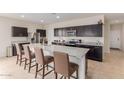 Modern kitchen featuring granite countertops, stainless steel appliances, and a large center island with seating at 1021 W Descanso Canyon Dr, Casa Grande, AZ 85122