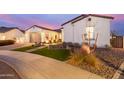 Well maintained home displaying landscaped yard including stone and grass design elements at 11143 N Mckinney St, Surprise, AZ 85388