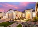 Home exterior with a manicured front yard, beautiful facade, and a multi-car garage at 11143 N Mckinney St, Surprise, AZ 85388