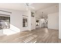 Inviting living room features vaulted ceilings, light-colored wood floors and neutral paint at 1157 W Edgewater Dr, Gilbert, AZ 85233