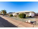 Inviting single-story home featuring well-maintained desert landscaping and a clear blue sky at 13234 W Desert Glen Dr, Sun City West, AZ 85375