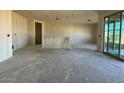 Spacious living room with large sliding glass doors offers tons of natural light at 15752 W Beryl Ave, Waddell, AZ 85355