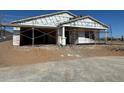 New home in construction phase showing the framing of the house with a two-car garage and covered entry at 15762 W Cheryl Dr, Waddell, AZ 85355