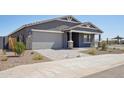 Inviting single-level home with a gray exterior and a two-car garage, set on a landscaped lot at 15762 W Cheryl Dr, Waddell, AZ 85355