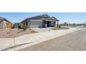 Beautiful single-Gathering home featuring a well-maintained yard and attached two-car garage at 15762 W Cheryl Dr, Waddell, AZ 85355