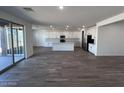 Open-concept kitchen featuring a large island, stainless steel appliances, and sliding glass doors at 15762 W Cheryl Dr, Waddell, AZ 85355