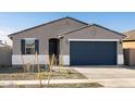 Charming single-story home featuring a gray stucco exterior, dark blue garage door and desert landscaping at 15993 W Cottontail Ln, Surprise, AZ 85387