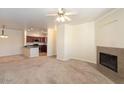 Spacious living room featuring a fireplace and open view of the modern kitchen at 16013 S Desert Foothills Pkwy # 2077, Phoenix, AZ 85048