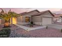 Charming single-story home with manicured desert landscaping and a two-car garage at 16412 N 168Th Ln, Surprise, AZ 85388