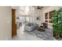 Open-concept living room featuring tile floors, neutral colors, and built-in shelving in this well-lit, modern home at 16643 N 19Th St, Phoenix, AZ 85022