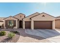 Charming single-story home with a desert-style front yard and a three-car garage at 16713 W Monte Vista Rd, Goodyear, AZ 85395