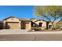 Inviting single-story home featuring a three-car garage and a well-maintained front yard at 1728 W Eagle Talon Trl, Phoenix, AZ 85085