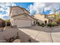 Wide shot of the side of a two-story home with a long driveway and desert landscaping at 20914 N 39Th Way, Phoenix, AZ 85050