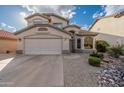 Home with a front yard featuring desert landscaping and an attached two-car garage at 20914 N 39Th Way, Phoenix, AZ 85050